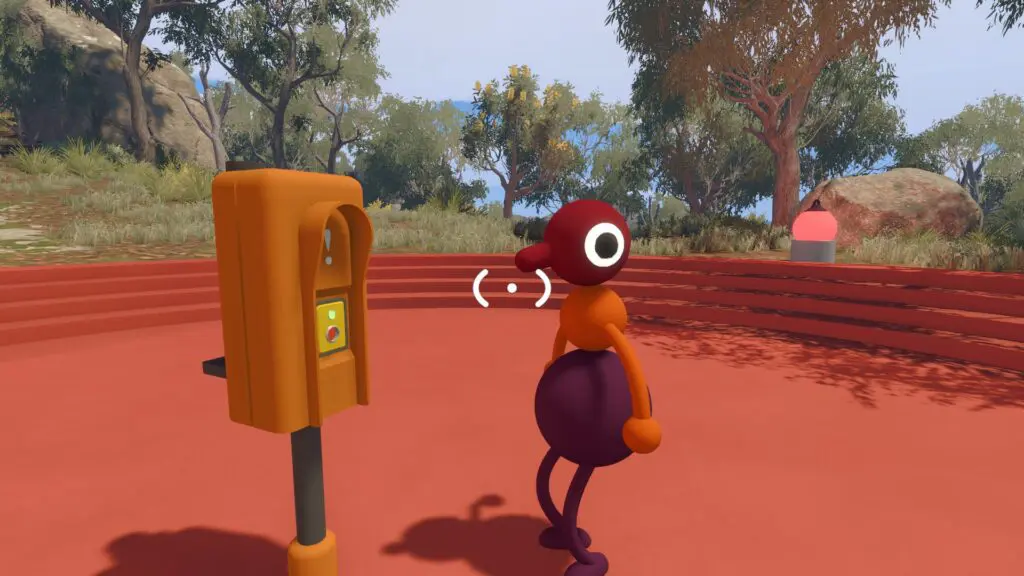 A Big Walk player waits beside an orange call-box-style landmark