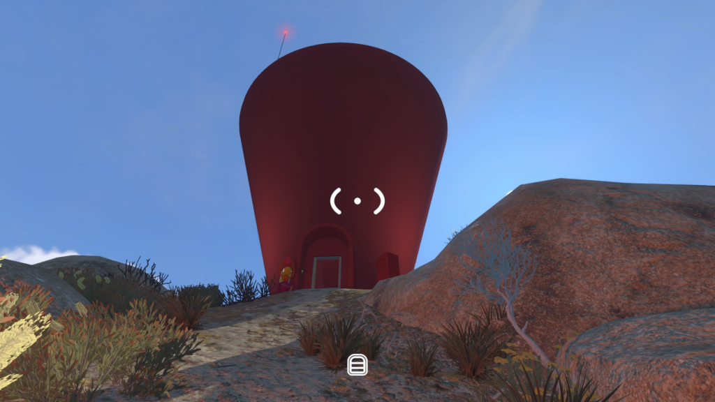 The tall red control-panel tower viewed from the uphill path