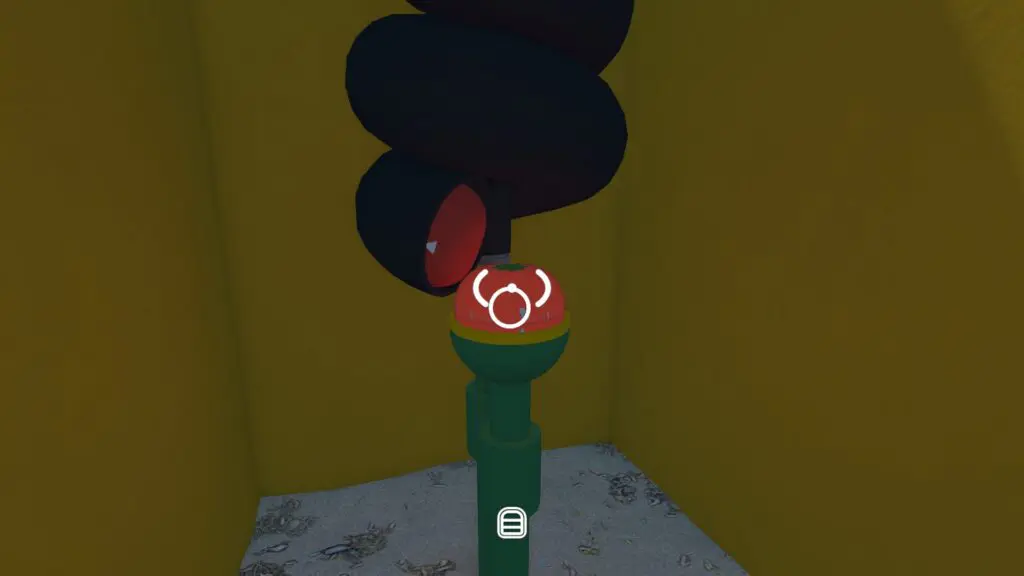 The tomato timer is positioned over its green-and-red holder inside the beach maze