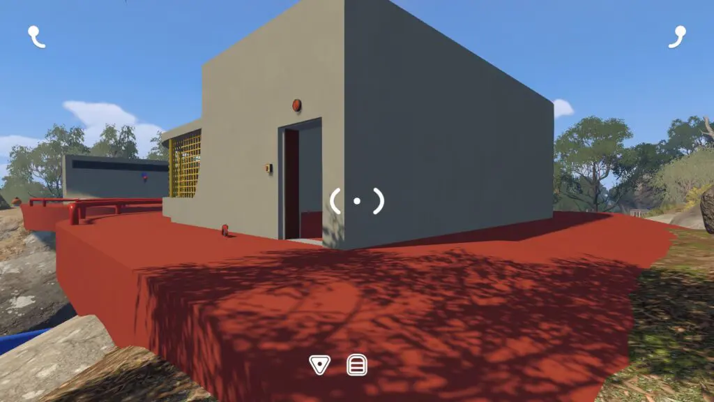 One grey button-room building sits on a red platform with a barred communication cage