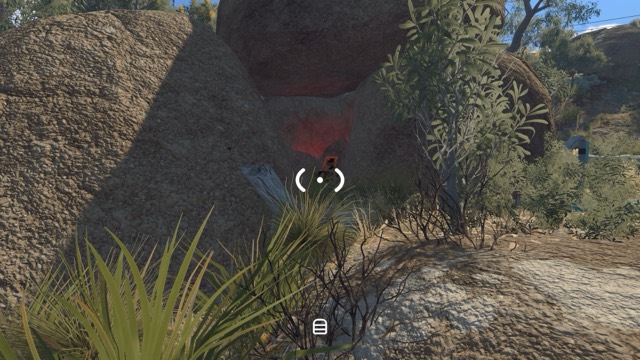 A musical reward box is concealed among large rocks near the speaker area